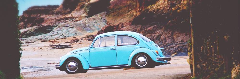 classic blue car on beach