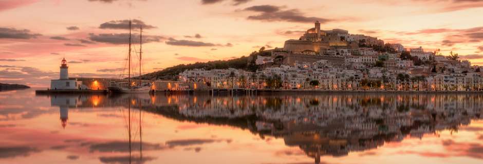 Old Town Ibiza across the water with sailing boat