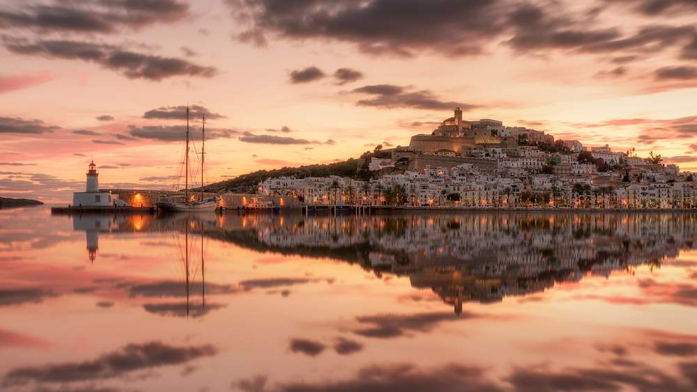 Old Town Ibiza across the water with sailing boat