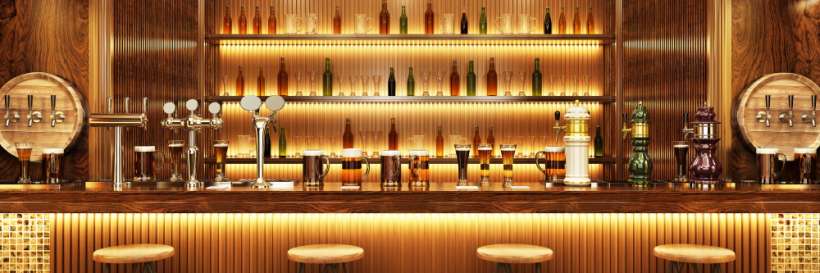 photograph of a well-lit bar with drinks on top