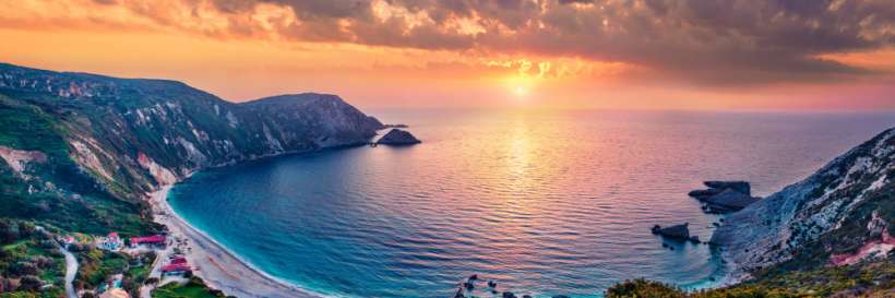 photo of a sunset over a greek island